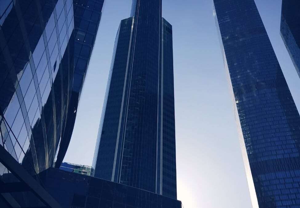 blue glass paneled buildings under clear blue sky